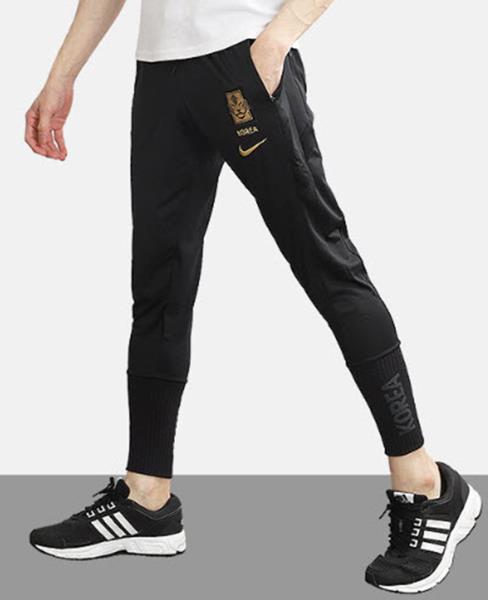 gold and black nike pants